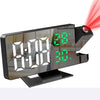 A black LED digital projection alarm clock displaying time, temperature, and battery percentage.