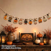 Vintage wooden Halloween flag set featuring pumpkins, ghosts, and moons displayed on a wall.