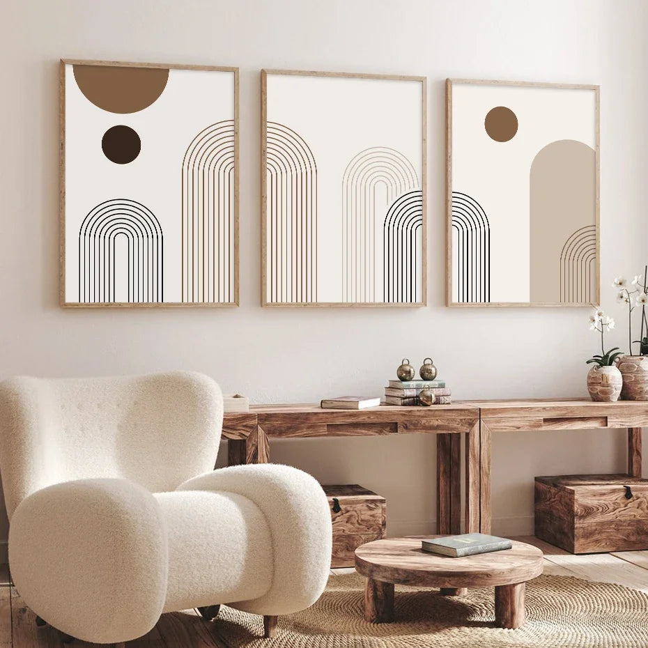 Un conjunto de tres obras de arte abstractas en lienzo enmarcadas con líneas y círculos geométricos en tonos neutros.