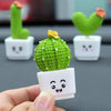 A hand holds a green crocheted cactus succulent alongside three other similar resin cacti for home decor.