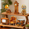 A collection of vintage-style miniature models including an old-fashioned lamp, a clock tower, and furniture pieces on a wood