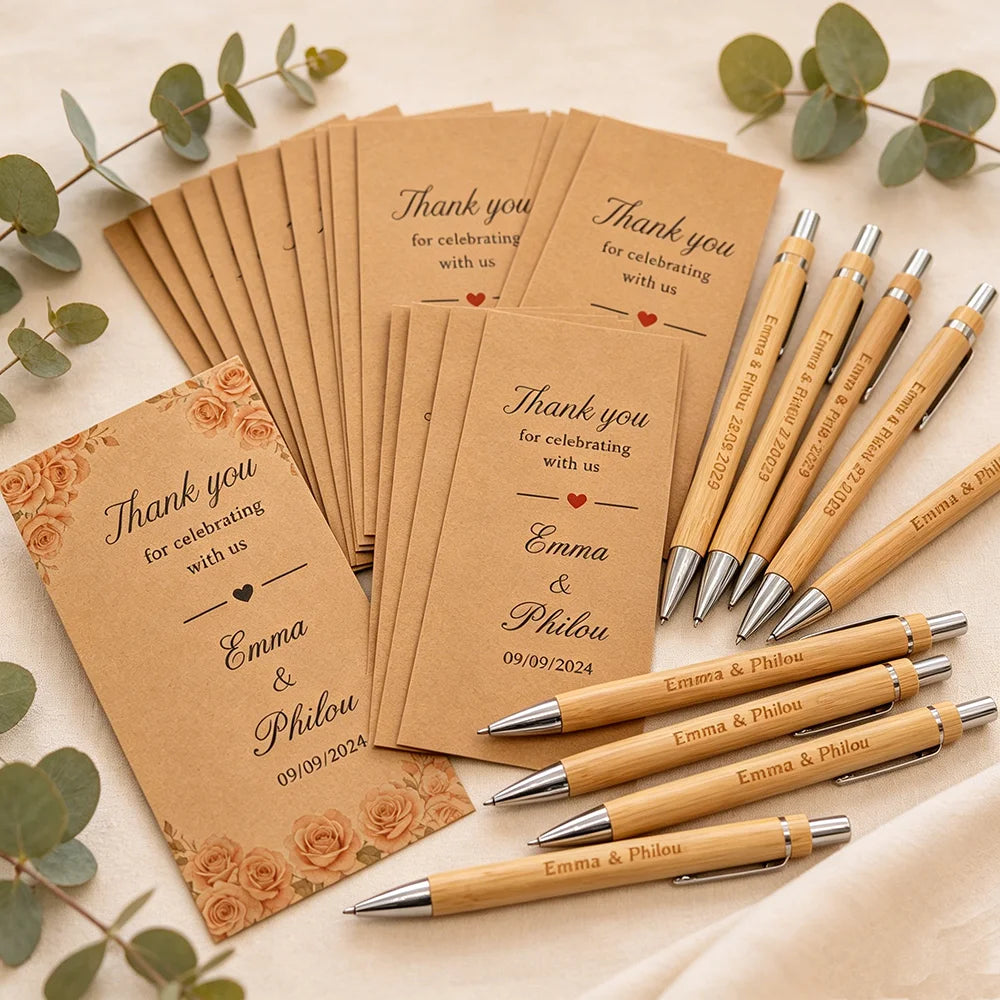 A set of personalized engraved bamboo pens and thank you cards for a celebration.