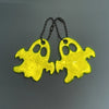 A set of two yellow ghost-shaped reflective keychains with black cords.