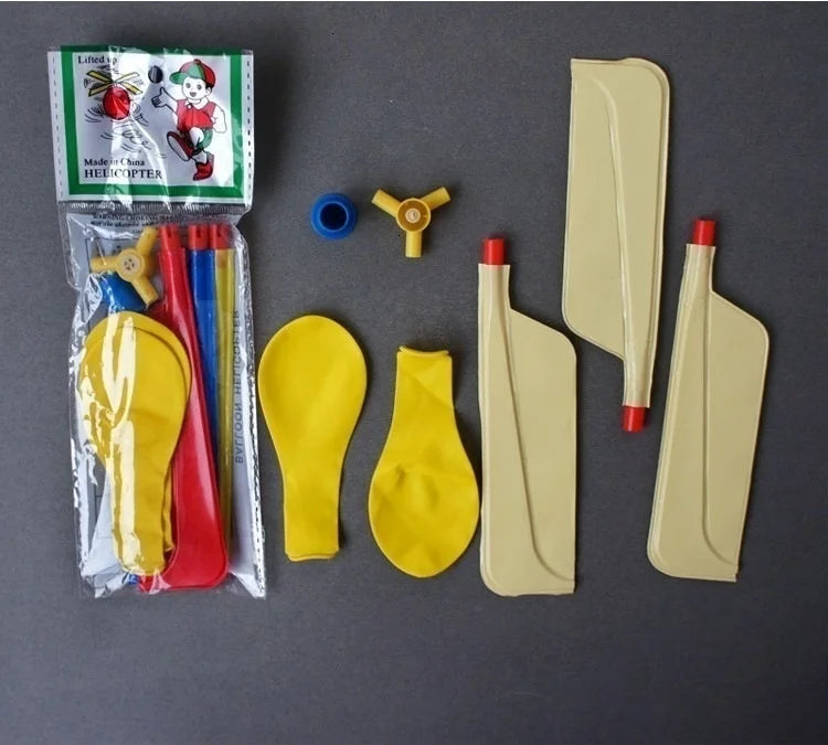 A set of whistling balloon helicopter toys including a model and various yellow and beige plastic parts.