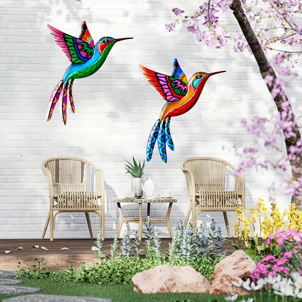 Vibrant metal hummingbird wall art featuring iridescent green, blue, and orange colors displayed against a white brick backgr