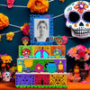 A wooden memory box for Día de los Muertos featuring a photo display and colorful floral decorations.