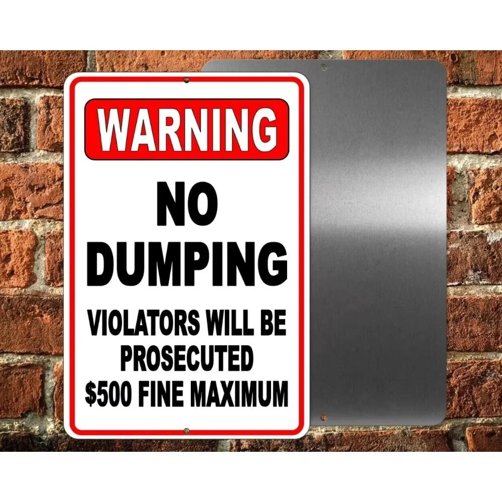 A rectangular red and white warning sign stating NO DUMPING and penalties for violators, mounted on a metal plate against a b