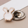 A small white rabbit shaped pearl and rhinestone no-sew brooch button with a silver finding.