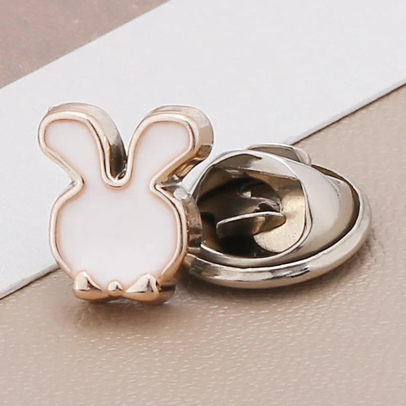 A small white rabbit shaped pearl and rhinestone no-sew brooch button with a silver finding.