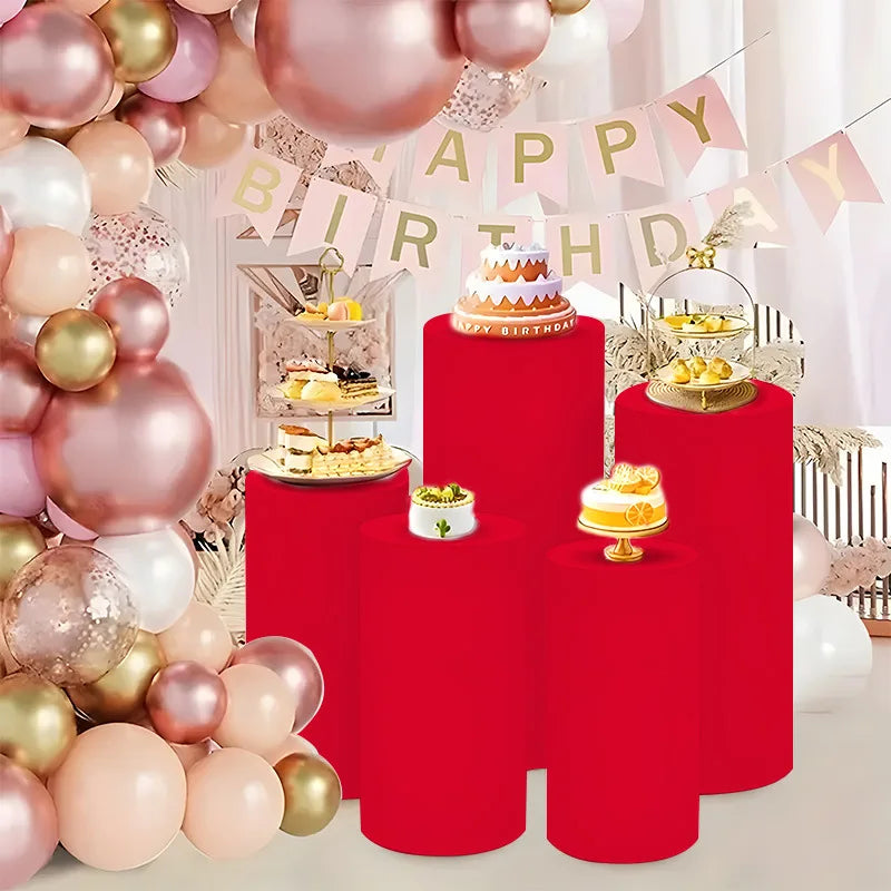 Red cylinder stands used as elastic covers for party and event decor with balloons and streamers