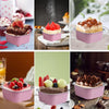 Pink reusable aluminum foil baking cups with lids and spoons filled with various baked goods like cakes and fruit