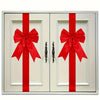 Pair of white cabinet doors decorated with red ribbon bows.