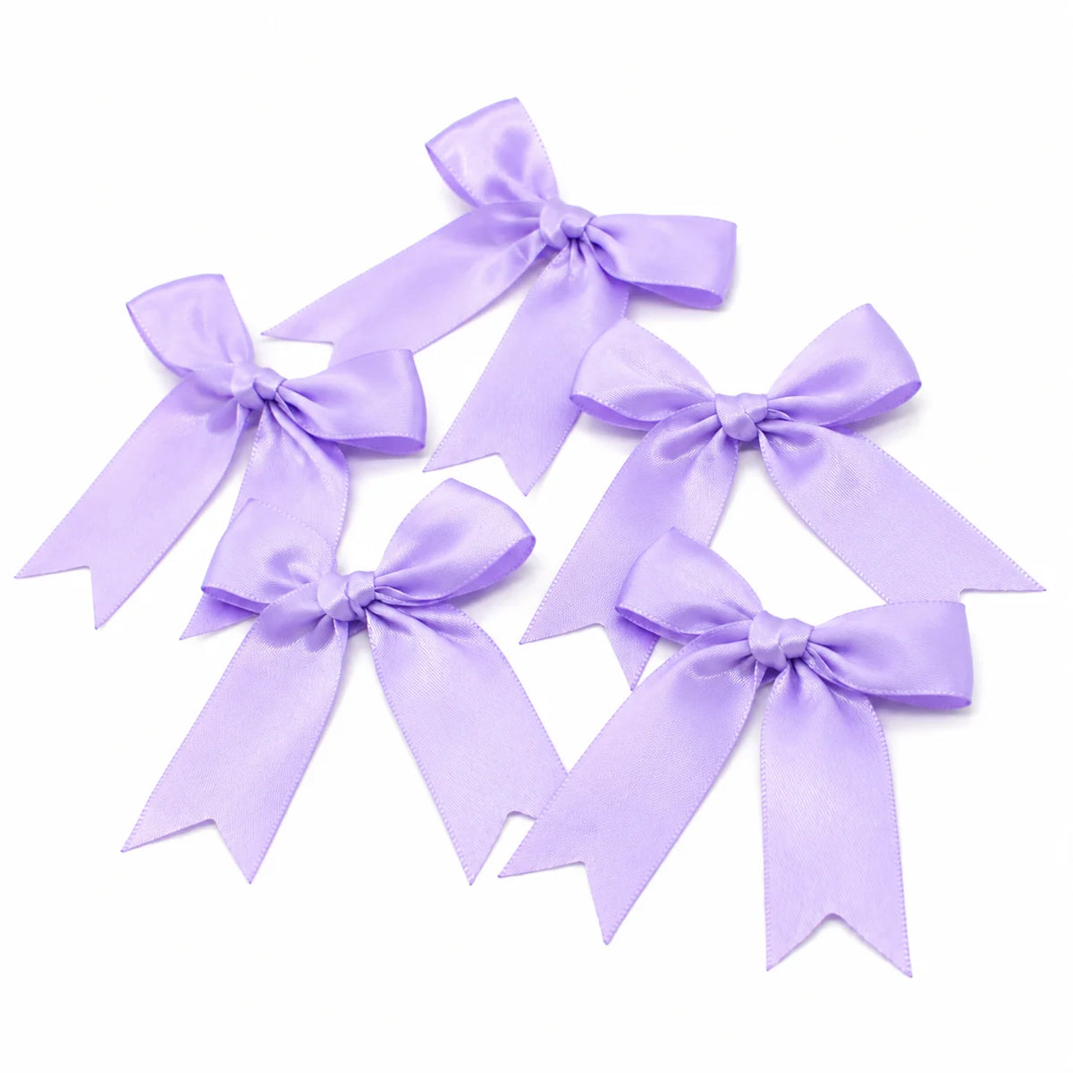 A collection of purple satin ribbon bows tied in various decorative styles.