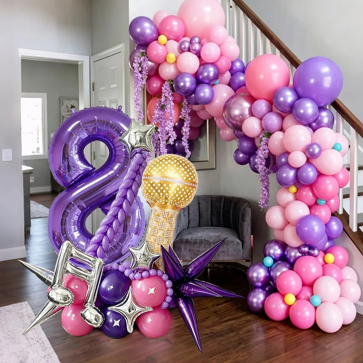 A large balloon arch featuring purple and pink balloons, a number eight, and decorative stars.