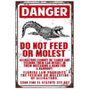 Vintage sign with red and black text warning against feeding or molesting alligators.