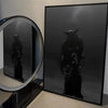 Black canvas wall art featuring a silhouette of a figure in a hood and mask.