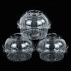 Three clear plastic cupcake boxes with domed lids displayed against a black background.