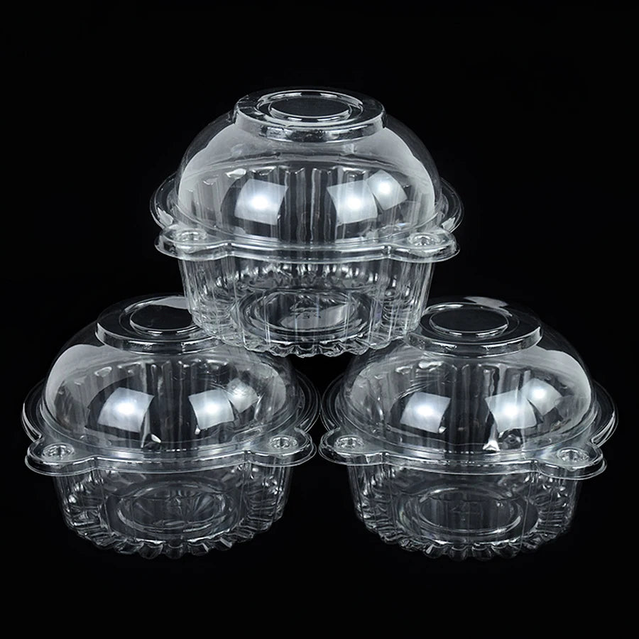 Three clear plastic cupcake boxes with domed lids displayed against a black background.