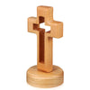 Handcrafted wooden cross standing ornament made of light-colored wood.