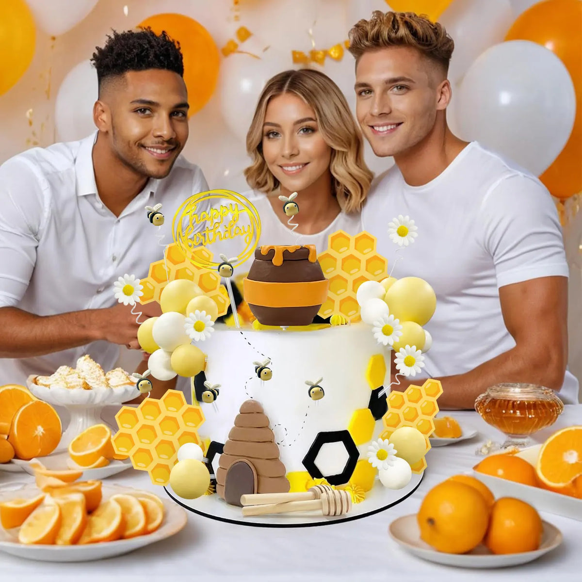 A birthday cake decorated with yellow honeycomb shapes, white and yellow balloons, and a honey jar on a white table.