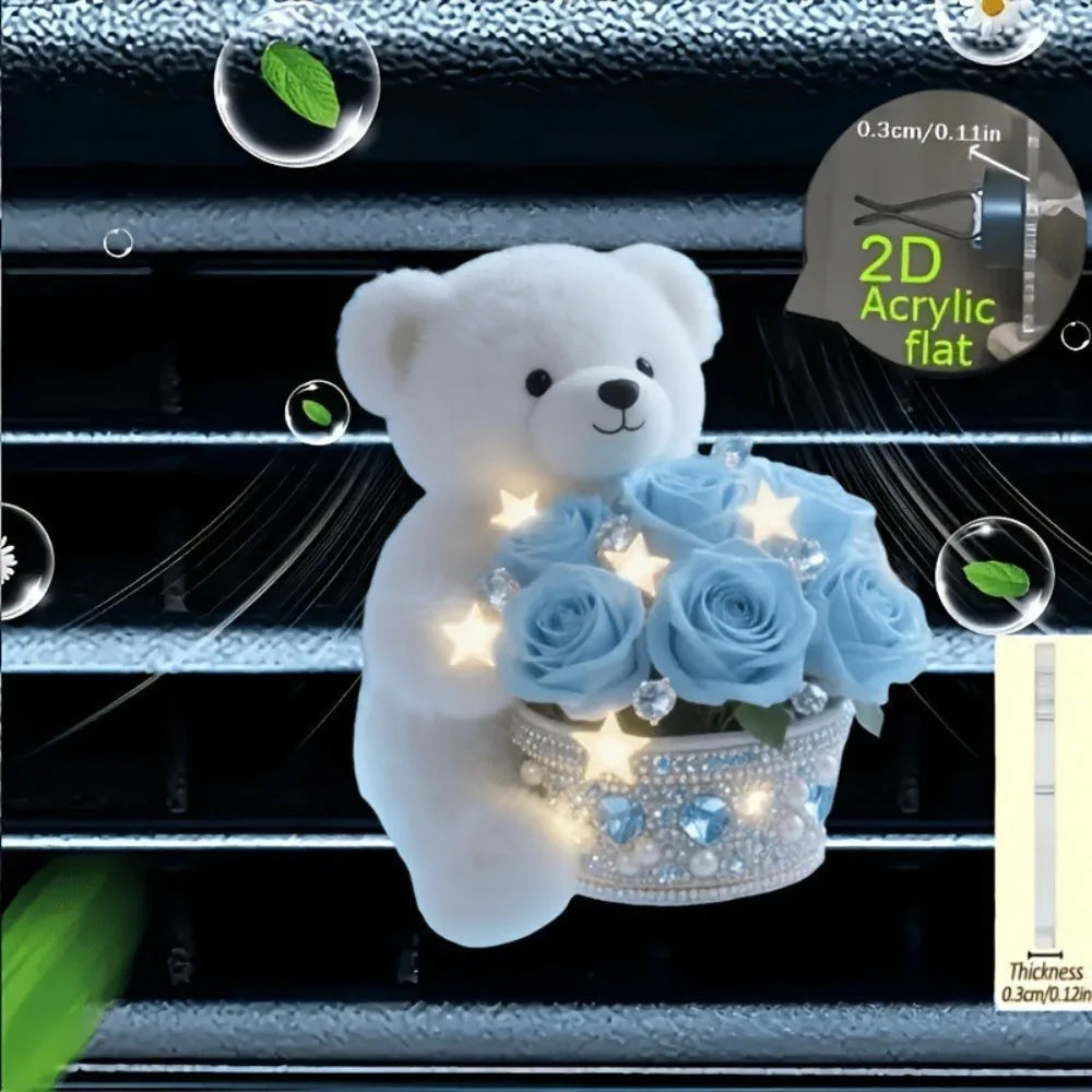 A white acrylic teddy bear holding a bouquet of blue roses, designed as a car vent clip decor.