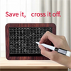Une main utilise un stylo blanc pour marquer des chiffres sur une boîte d'épargne en bois étiquetée « Save it cross it off ».