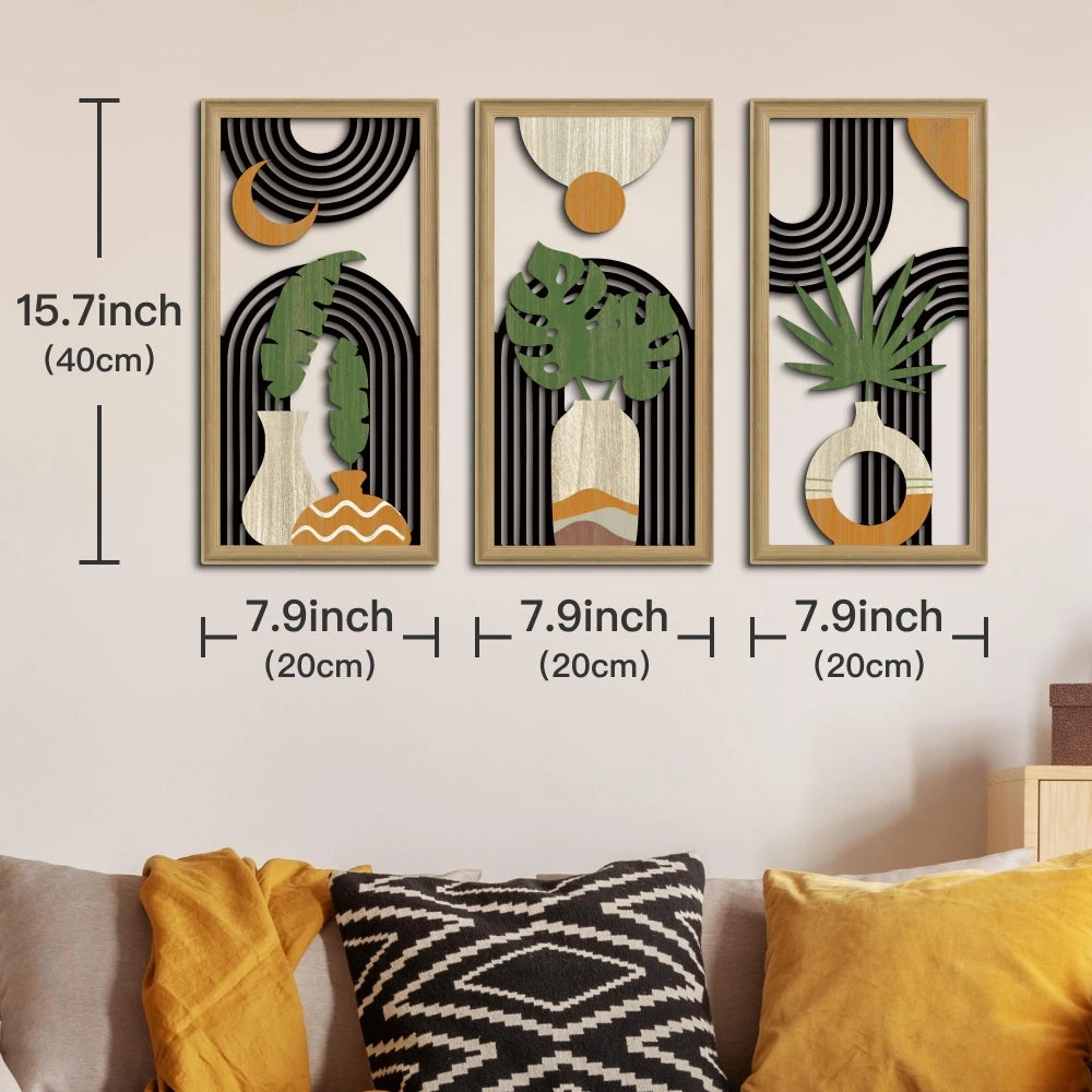 A set of three framed wall art pieces featuring botanical and geometric designs in natural wood tones.