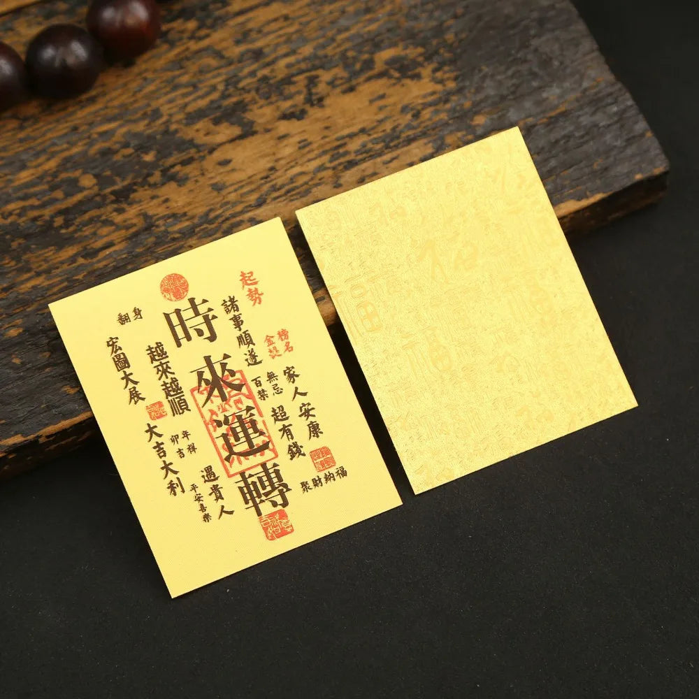 A yellow sticker with red Chinese characters for lucky wealth and prosperity is placed on a dark wooden surface.