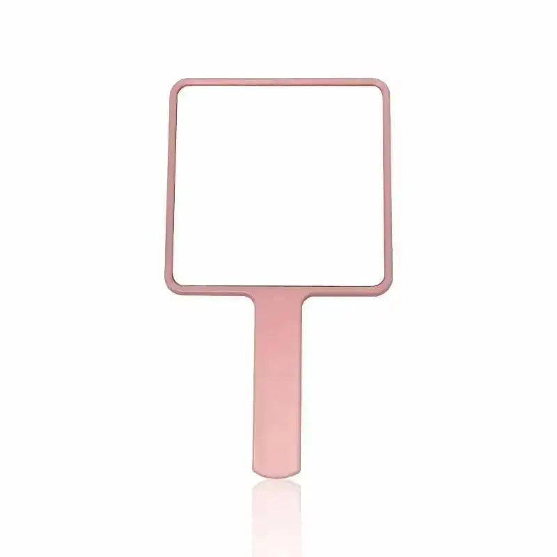 A rectangular, rose gold compact handheld makeup mirror with an ergonomic handle.