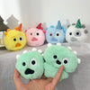 A hand holds a collection of pastel-colored plush toys with spiky hair and clear photocard holders.