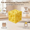 A yellow cheese squishy toy cube shown with features like super soft texture, slow rising, perfect gift packaging, and compac