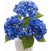 A bouquet of large, vibrant blue artificial hydrangea flowers in a white vase.