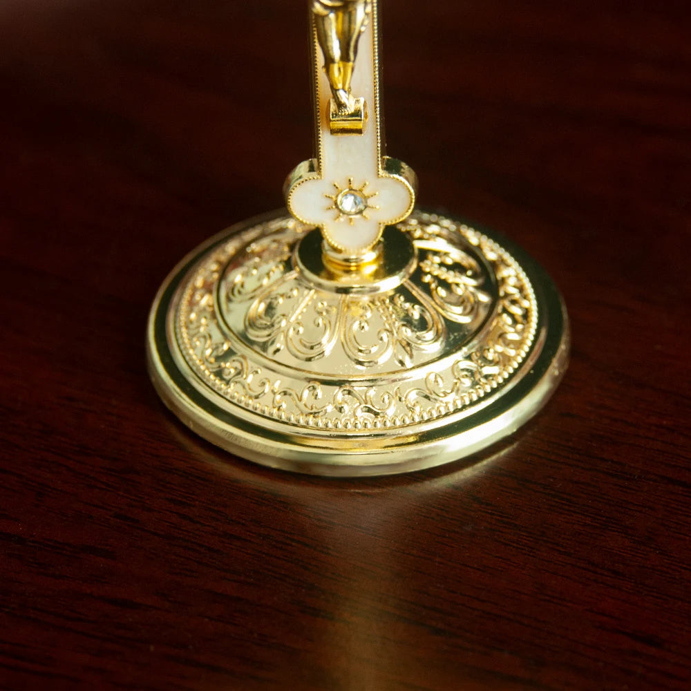 Elegant gold metal Jesus cross ornament with a decorative base for home or church
