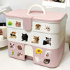 A pink and white storage box featuring various funny cat meme cartoon decals.