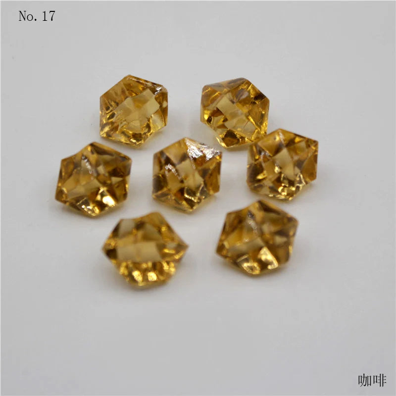 A collection of seventeen golden yellow crystal ice cube acrylic stones for decorative use.