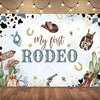 A watercolor illustration of a Wild West cowboy birthday backdrop featuring a brown hat, gold horseshoe, and various rustic e