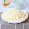 A bowl filled with white natural soy wax flakes for DIY candle making