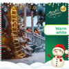 A festive Christmas scene featuring a decorated tree with a glowing ladder and a Santa figure in a snowy outdoor setting.