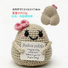 A handmade crochet potato doll with a smiling face and a card that reads Positive potato