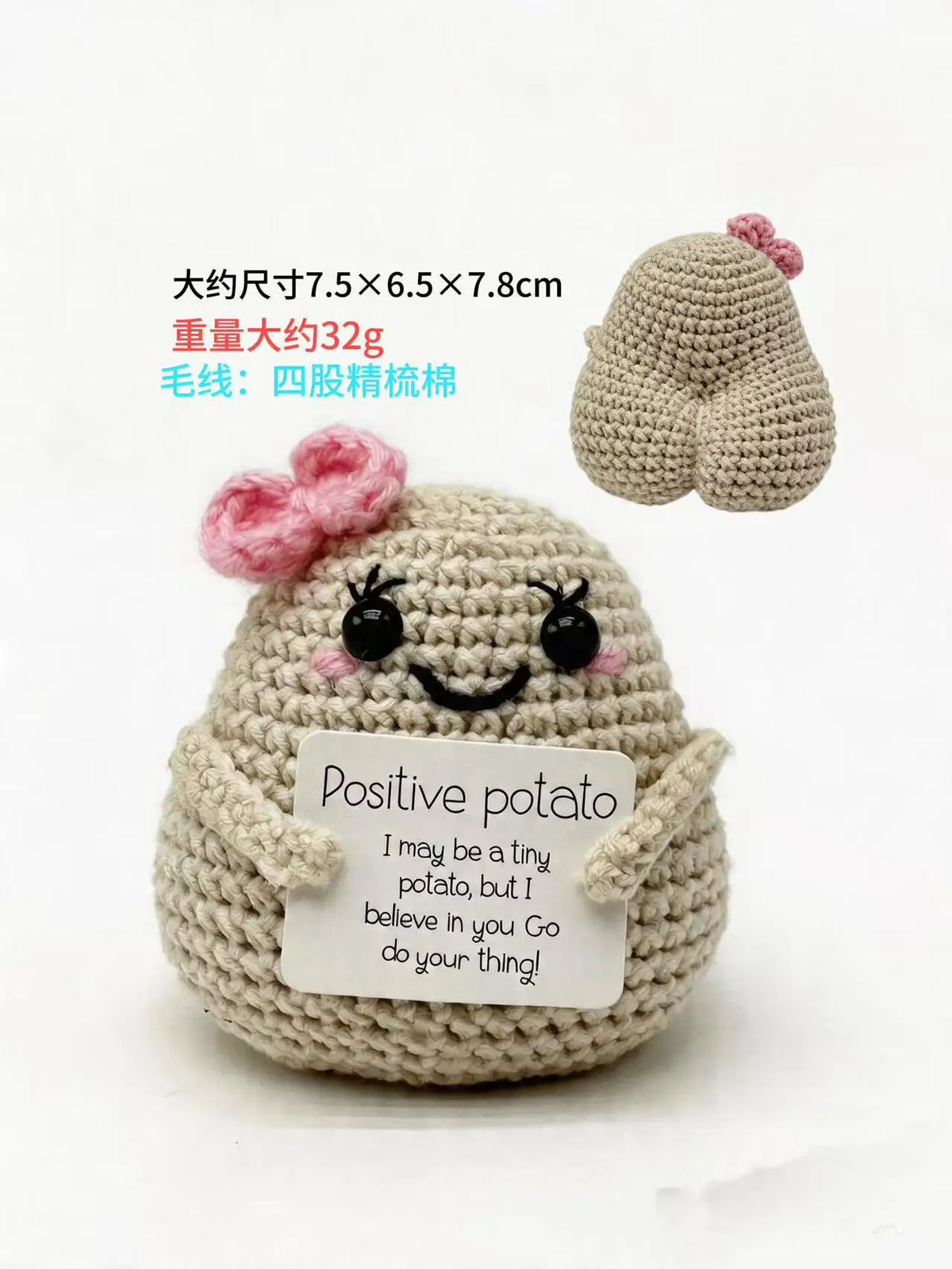A handmade crochet potato doll with a smiling face and a card that reads Positive potato