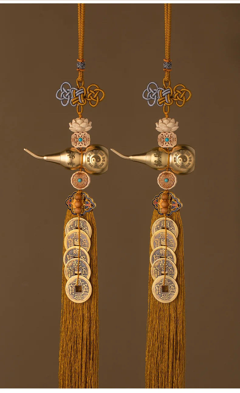 A pair of brass gourd and five emperor coins hanging ornaments with golden threads.