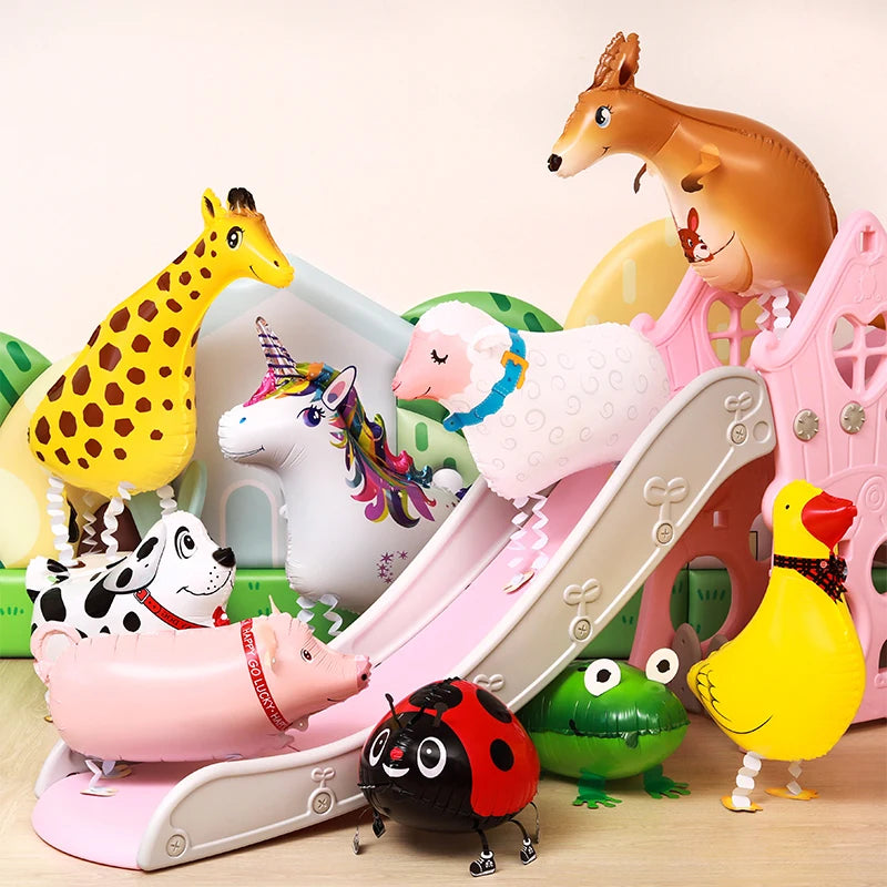 A collection of cartoon farm animal foil balloons including a giraffe, a white horse, a pig, and a yellow chicken.