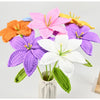 A hand-crocheted bouquet of colorful artificial lily flowers in shades of pink, orange, purple, and white.