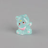 A small, translucent blue resin cat keychain with pink accents and glitter.