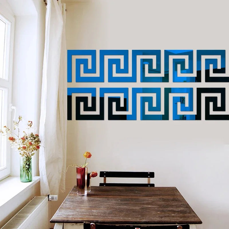 A decorative wall sticker featuring a blue and black Greek key pattern on a white wall.