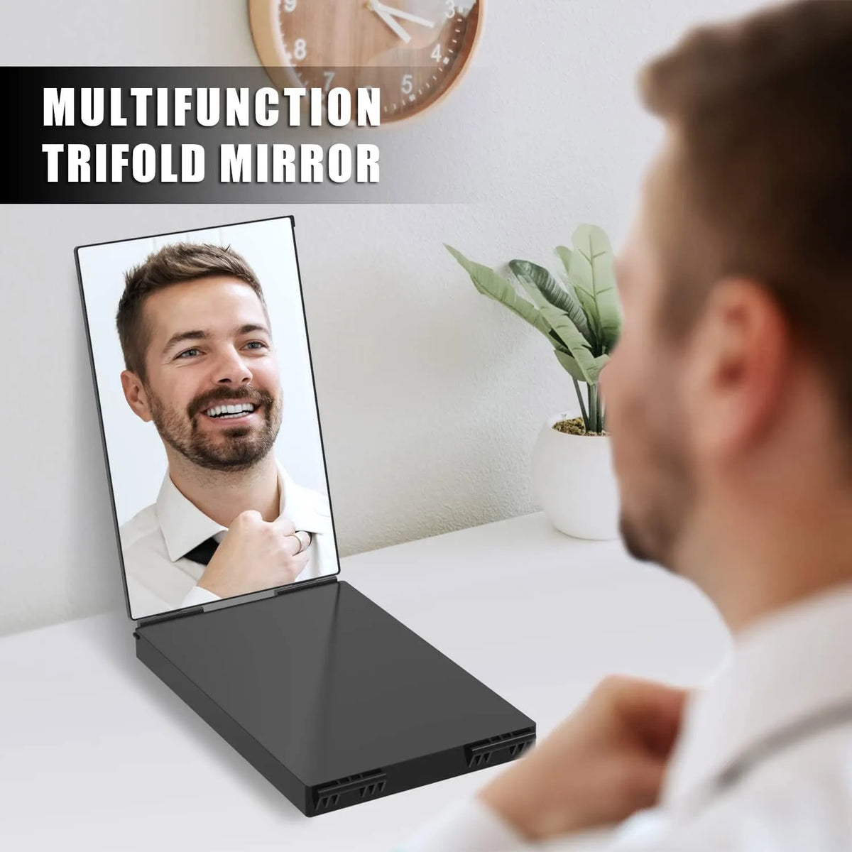 A close-up of a man using a multifunction trifold mirror on a white desk.