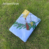 A folded Guatemala National Flag on green grass with a decorative tag.