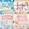 A collection of pink and blue foil letter balloons spelling out Happy Birthday for party decoration.