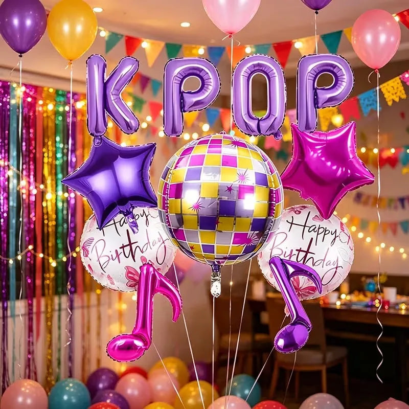 A colorful balloon decoration featuring large foil letters and stars in purple, pink, and gold for a party.