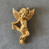 A golden cherub angel figurine with wings, sculpted in a classical style.